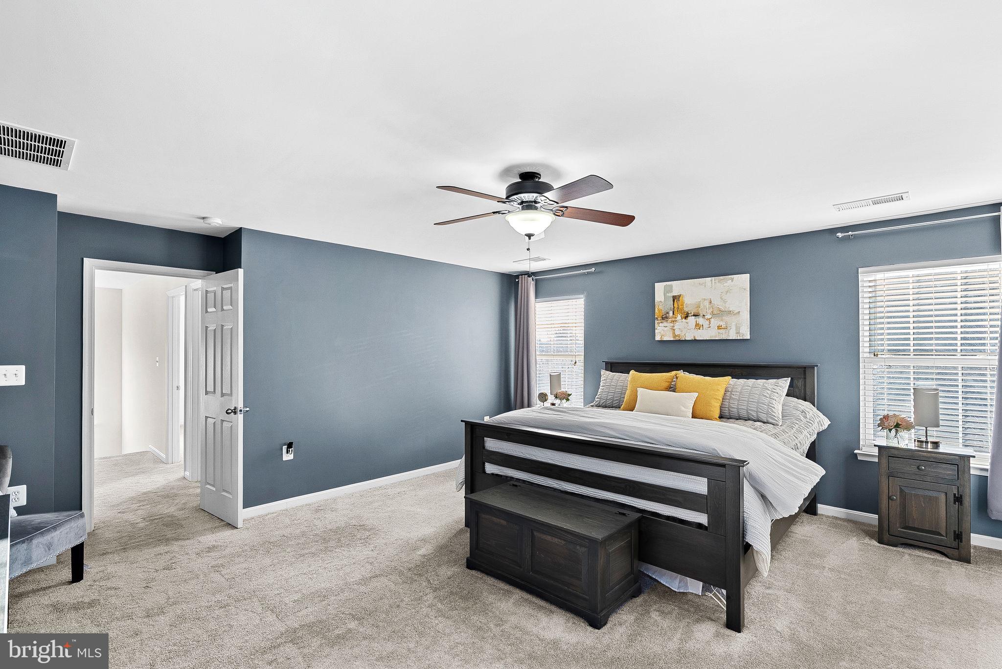 809 Devonshire Circle Purcellville, VA 20132 - Photo 19 of 36 a bedroom with a bed and a chandelier