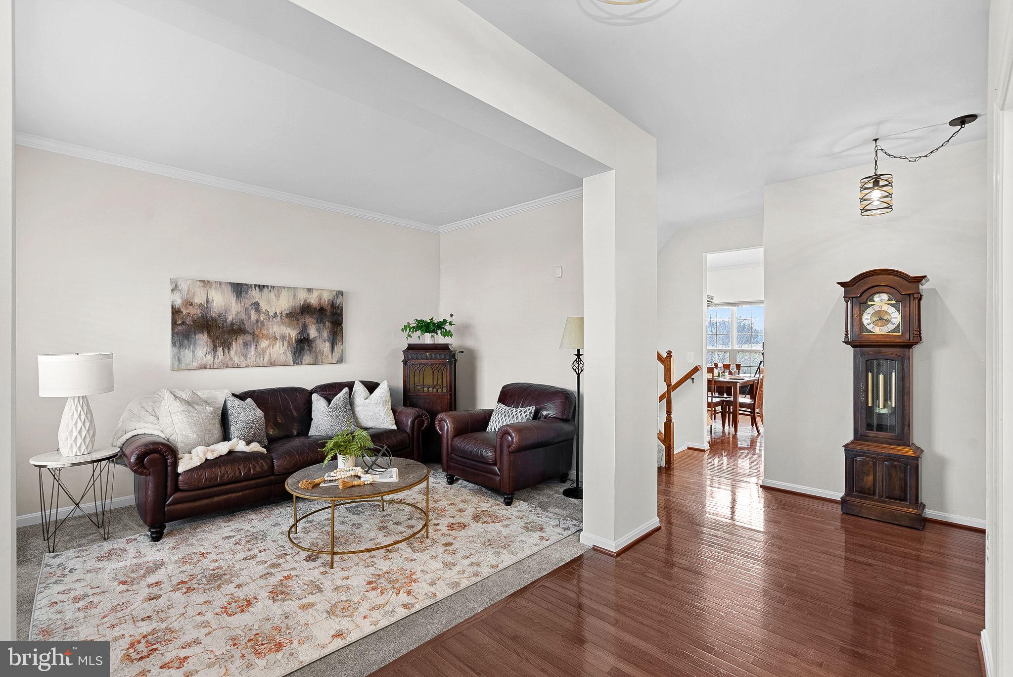 809 Devonshire Circle Purcellville, VA 20132 - Photo 4 of 36 a living room with furniture a rug and a wall painting