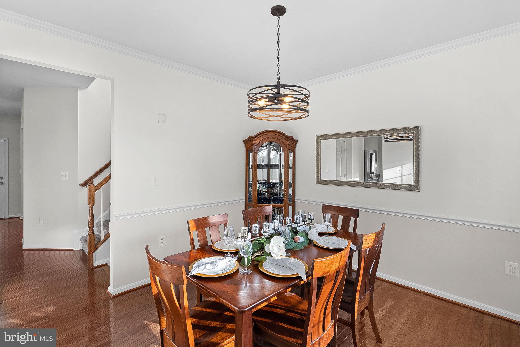 809 Devonshire Circle Purcellville, VA 20132 - Photo 7 of 36 a view of a dining room with a table chairs and chandelier
