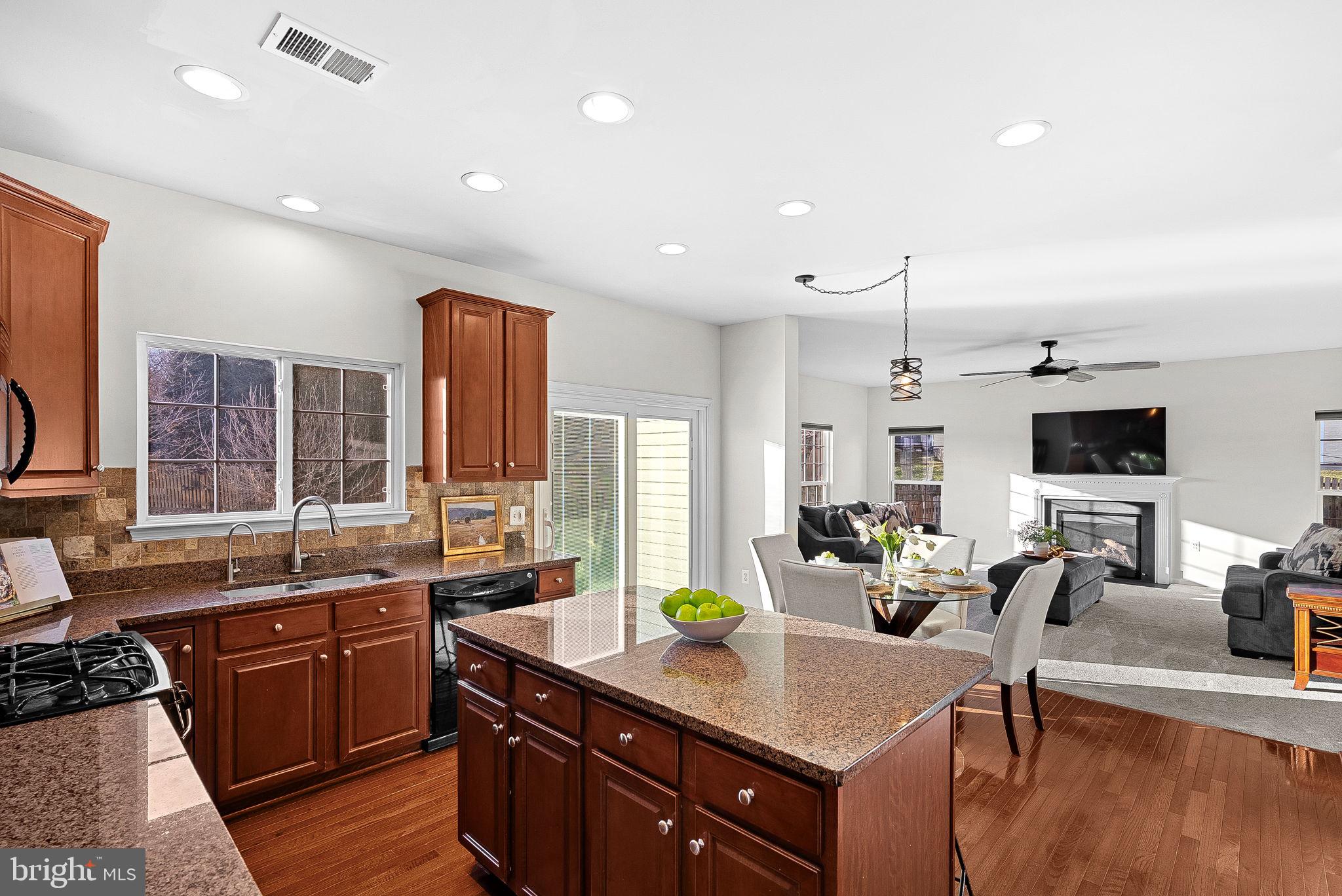 809 Devonshire Circle Purcellville, VA 20132 - Photo 10 of 36 a kitchen with a stove a sink a dining table and chairs