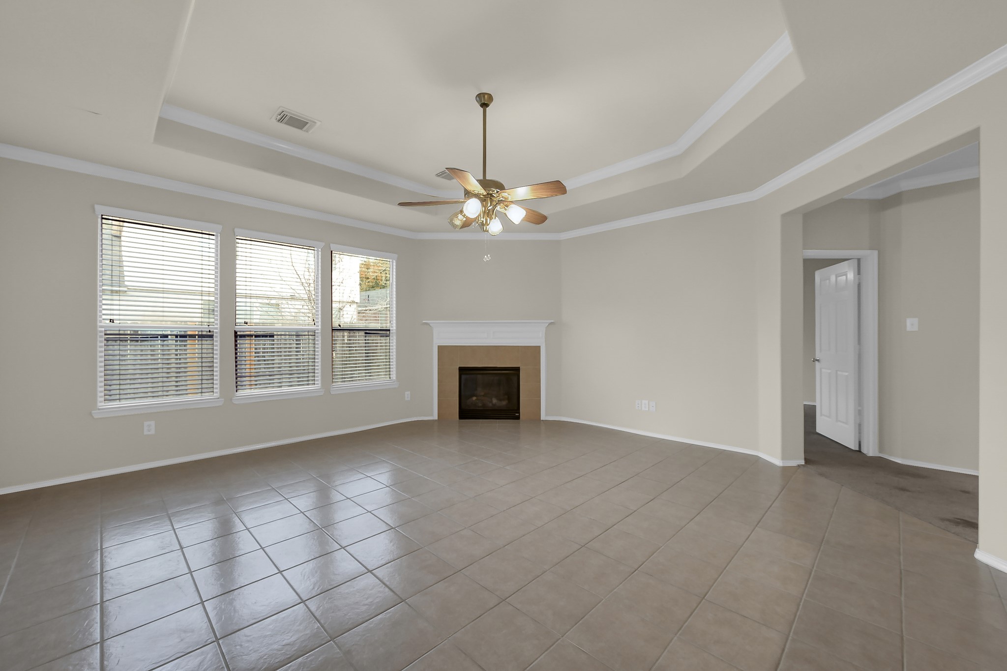 951 Crannog Way Conroe, TX 77301 - Photo 11 of 43 a view of an empty room with a fireplace and a window