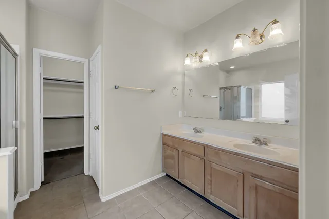 a bathroom with a shower and a glass door