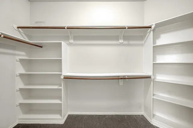 a view of a hallway with a wooden shelves