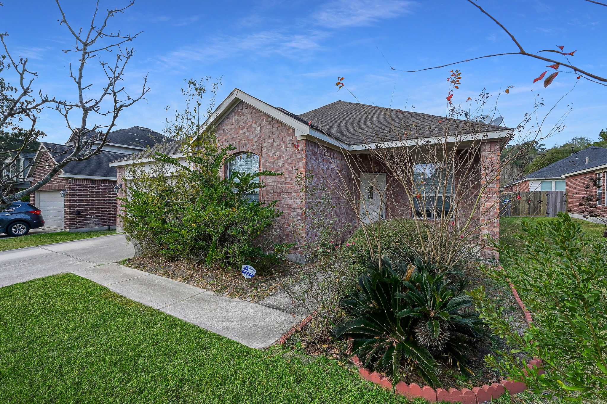 951 Crannog Way Conroe, TX 77301 - Photo 3 of 43 a backyard of a house with plants and outdoor seating