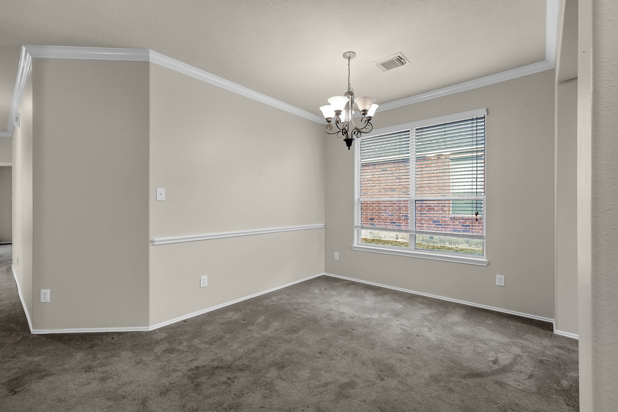 951 Crannog Way Conroe, TX 77301 - Photo 6 of 43 an empty room with chandelier fan and windows