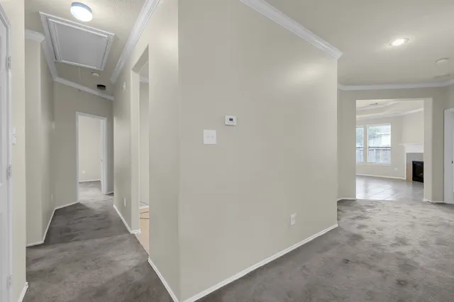 an empty room with windows and fireplace