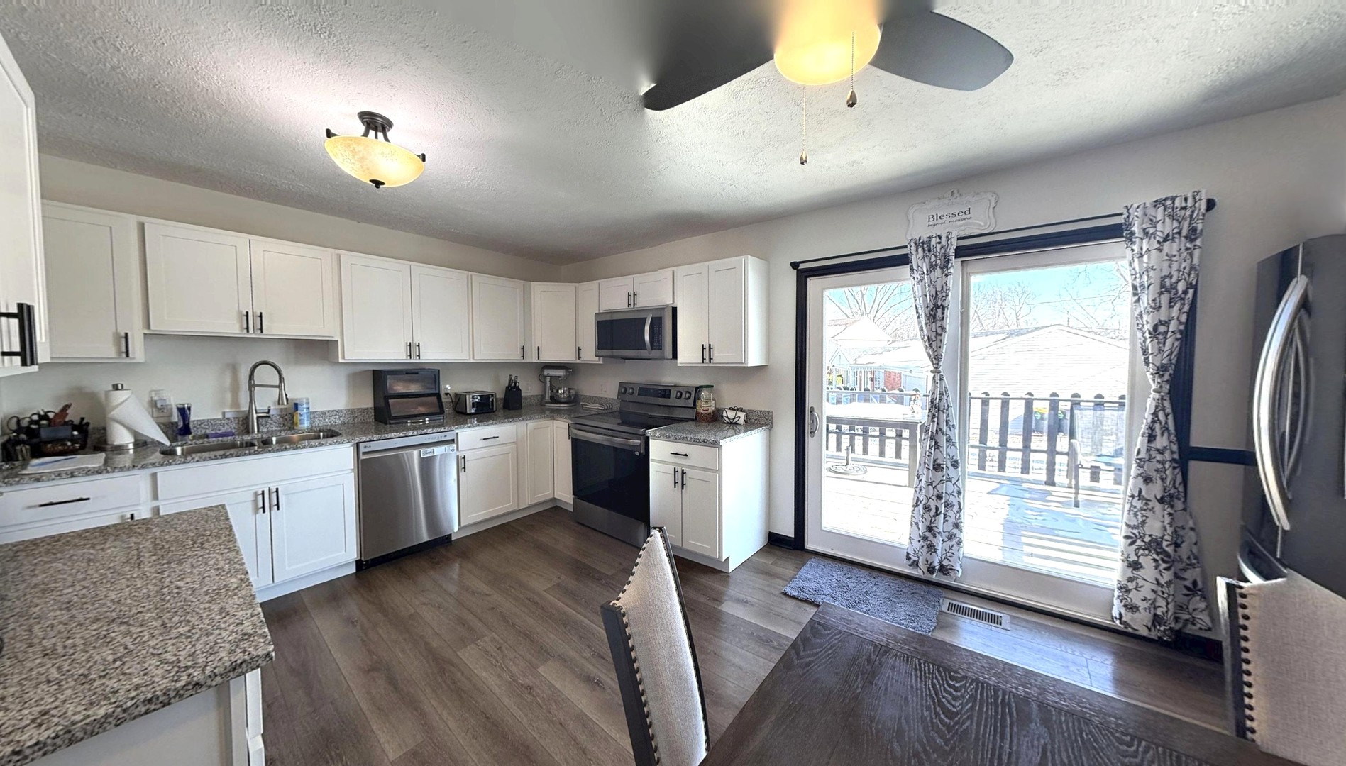 543 Ridge Circle Streamwood, IL 60107 - Photo 6 of 21 a kitchen with granite countertop stainless steel appliances a sink window and cabinets