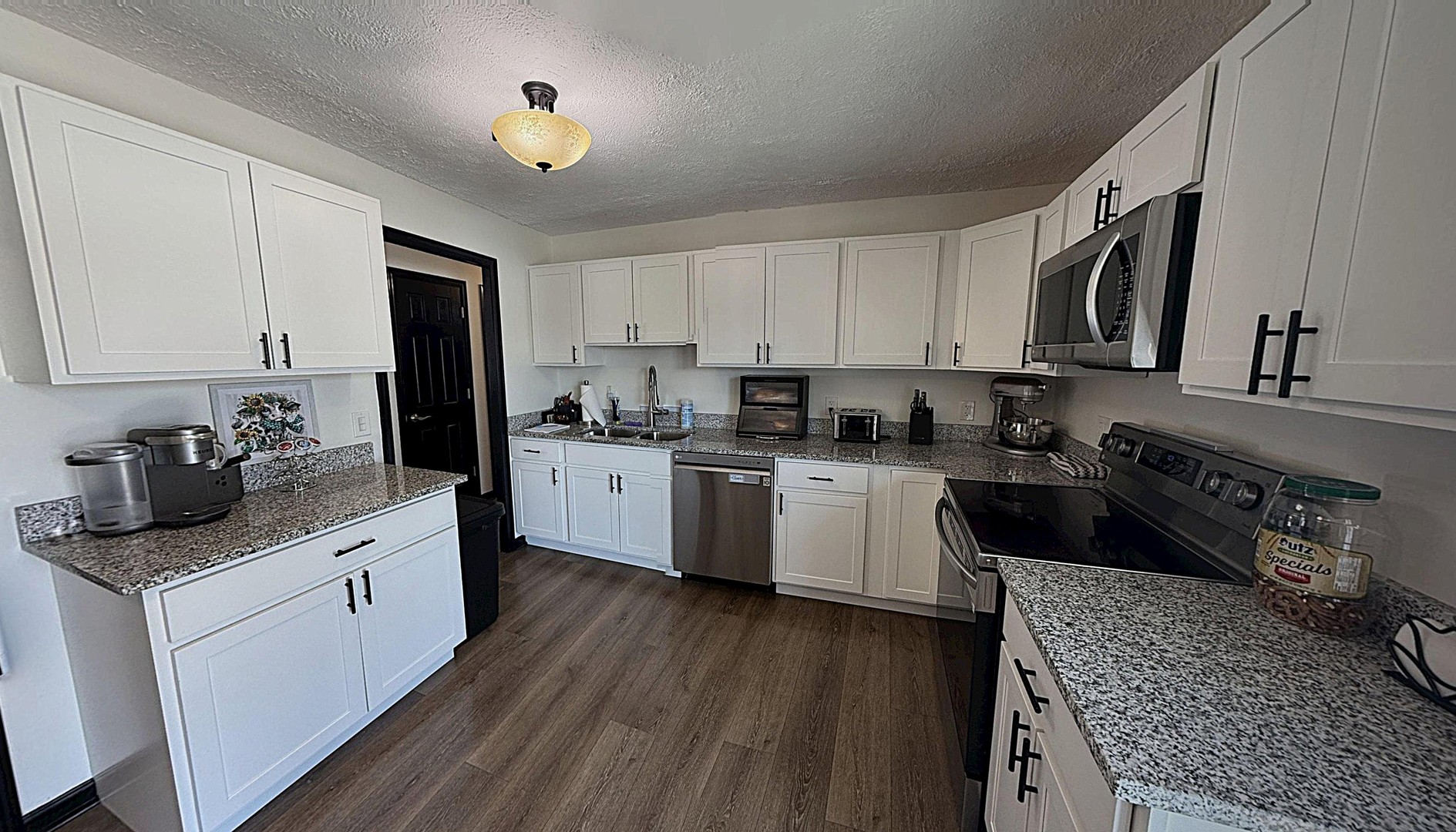 543 Ridge Circle Streamwood, IL 60107 - Photo 7 of 21 a kitchen with stainless steel appliances granite countertop a stove a sink dishwasher and a refrigerator with wooden floor