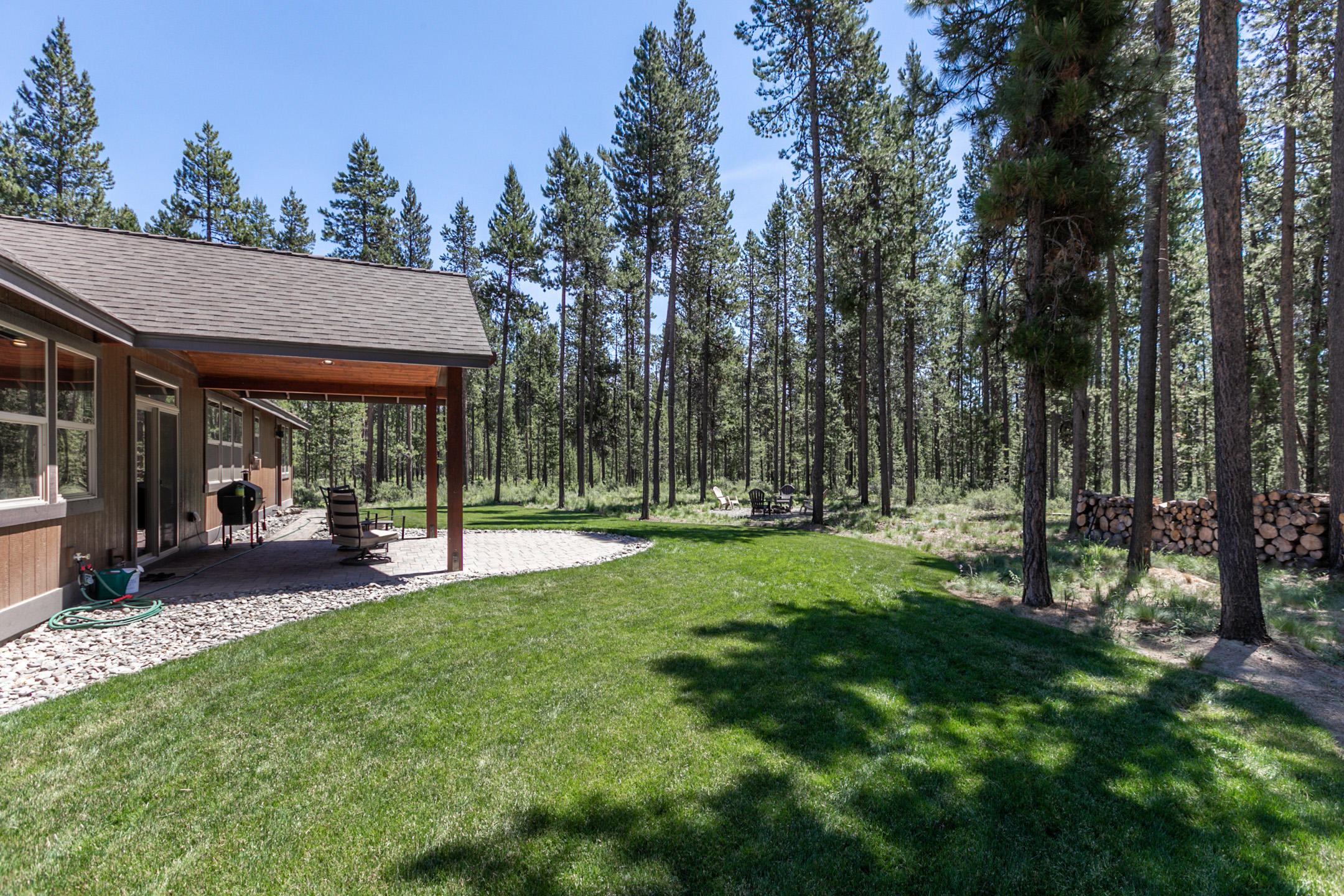 17067 Glendale Road Bend, OR 97707 - Photo 7 of 29 a view of a patio with table and chairs and floor to ceiling window