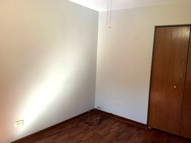 an empty room with wooden floor