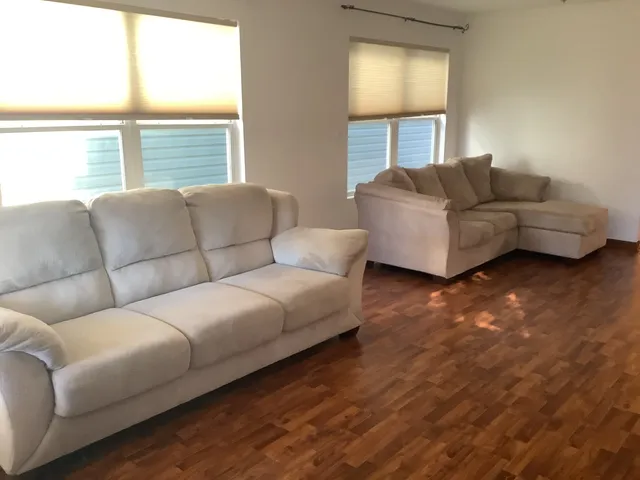 a living room with furniture and a window