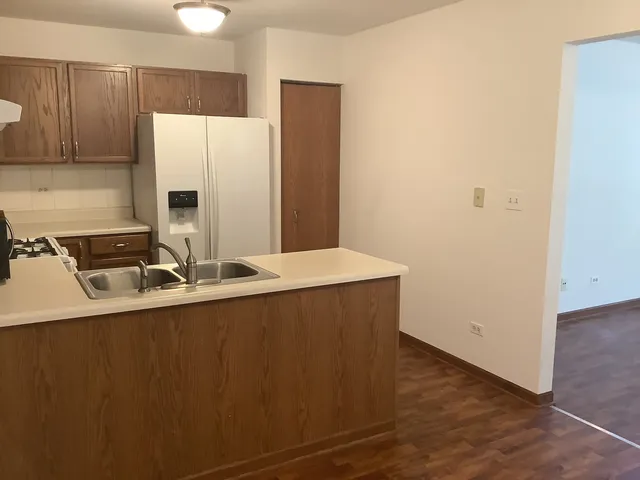 a kitchen with stainless steel appliances a sink and a refrigerator