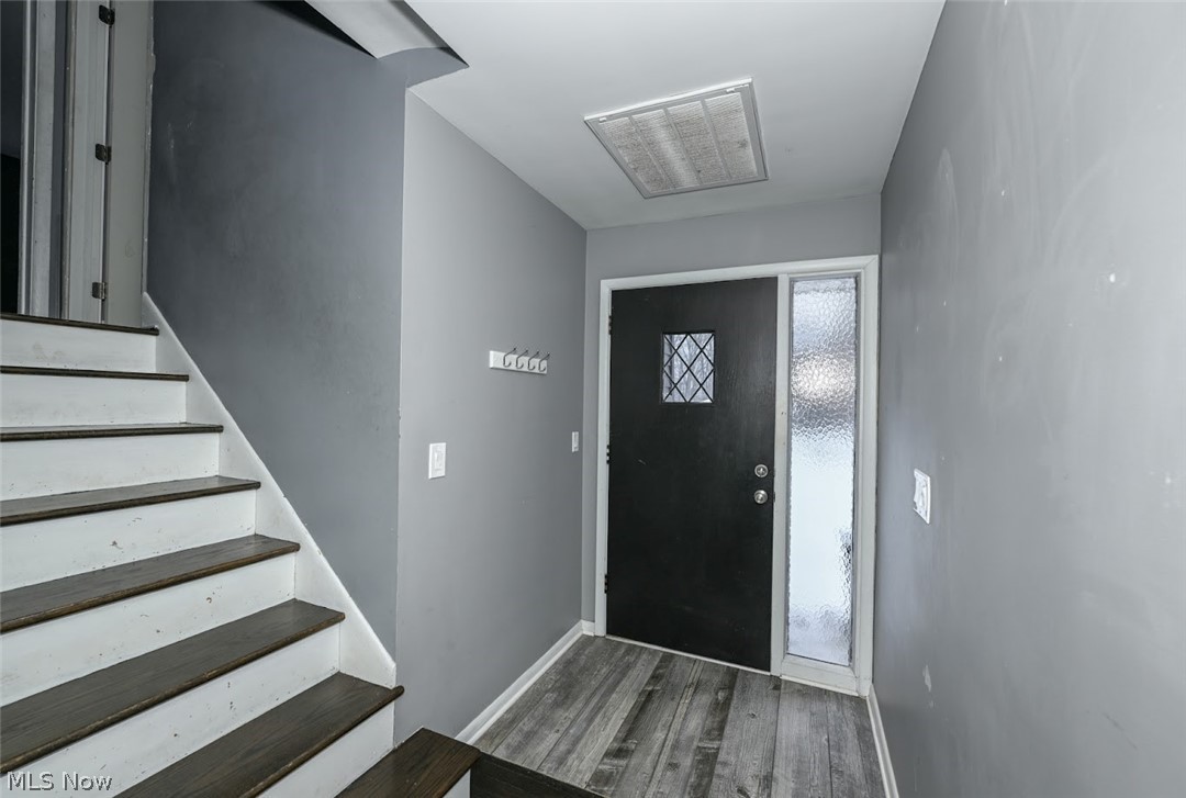 5766 Weaver Road New Franklin, OH 44319 - Photo 11 of 41 Foyer featuring stairs and dark wood-type flooring