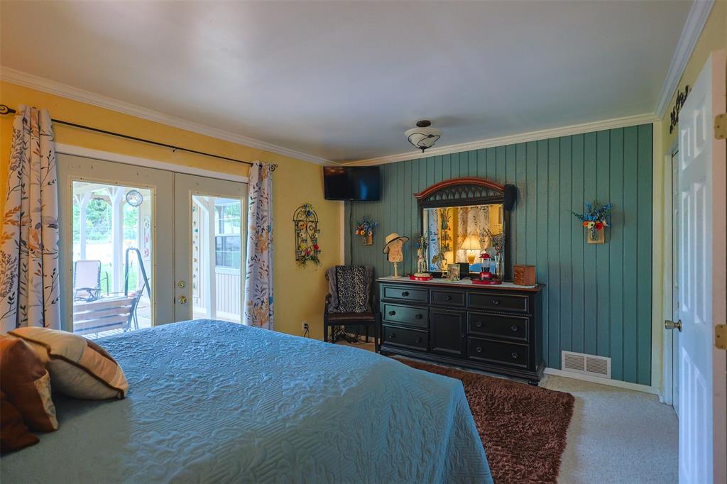 309 Tejas Trail Springtown, TX 76082 - Photo 18 of 40 a bed room with a bed and a mirror