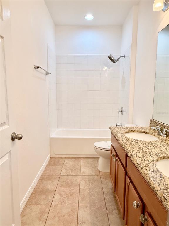 619 Fortanini Circle Ocoee, FL 34761 - Photo 22 of 36 a bathroom with a granite countertop sink a toilet and shower