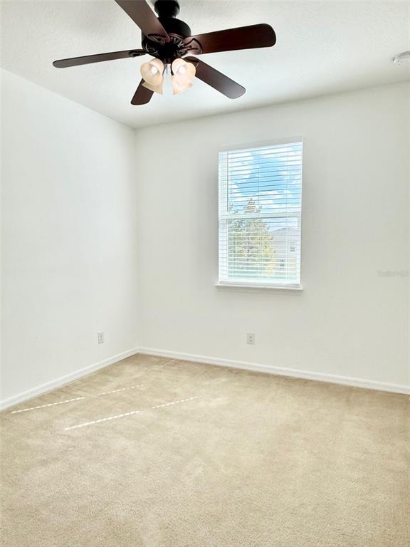 619 Fortanini Circle Ocoee, FL 34761 - Photo 24 of 36 an empty room with a window and a ceiling fan