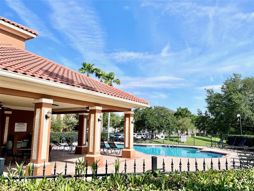 619 Fortanini Circle Ocoee, FL 34761 - Photo 33 of 36 a view of a swimming pool with a patio