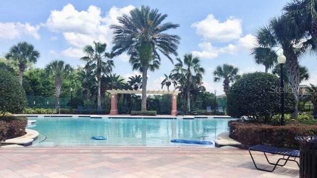 619 Fortanini Circle Ocoee, FL 34761 - Photo 34 of 36 a lake view with a garden and statue