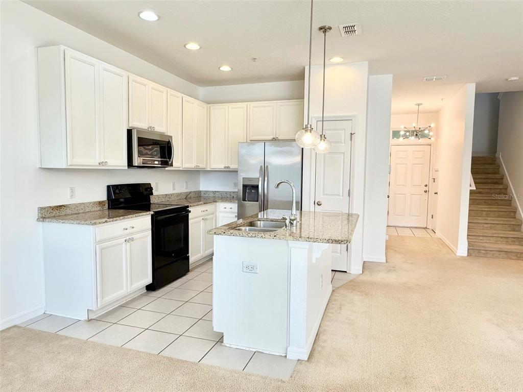 619 Fortanini Circle Ocoee, FL 34761 - Photo 8 of 36 a kitchen with stainless steel appliances white cabinets a sink a stove a refrigerator and a oven