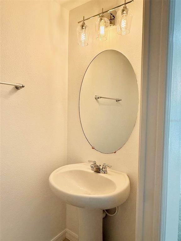 619 Fortanini Circle Ocoee, FL 34761 - Photo 10 of 36 a bathroom with a sink a mirror and a toilet
