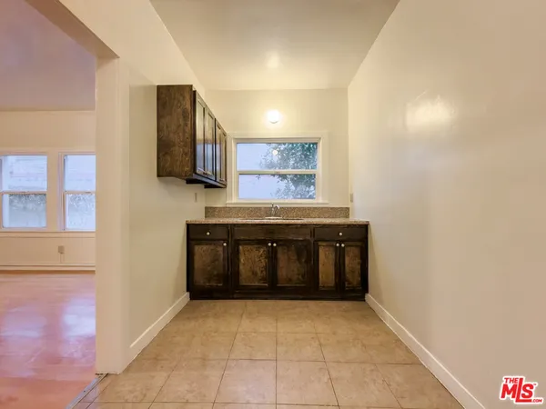 a hallway with a stove and a microwave