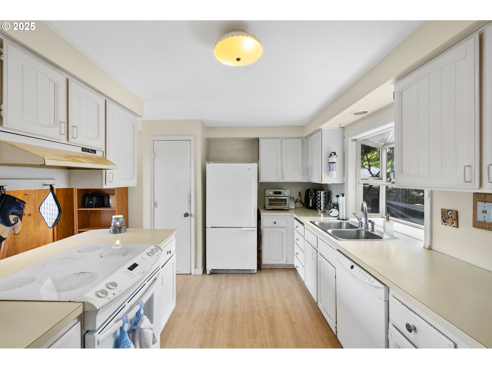 480 Northwest Norman Avenue Gresham, OR 97030 - Photo 11 of 40 a kitchen with a sink a counter top space stainless steel appliances and cabinets