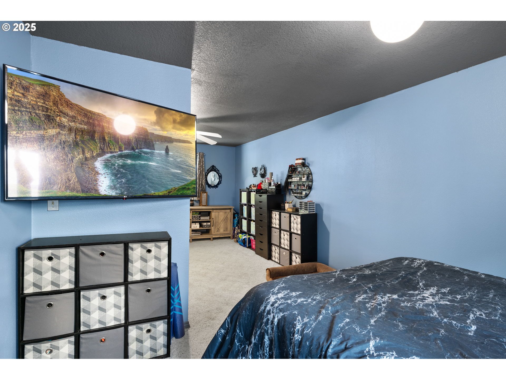 480 Northwest Norman Avenue Gresham, OR 97030 - Photo 18 of 40 a bedroom with a bed and a flat screen tv