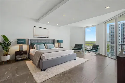 a spacious bedroom with a large bed and a couch