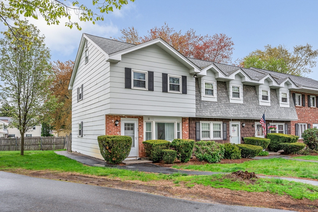 43 Constitution Way, Unit 43 Methuen, MA 01844 - Photo 2 of 25 a front view of a house with a yard and potted plants