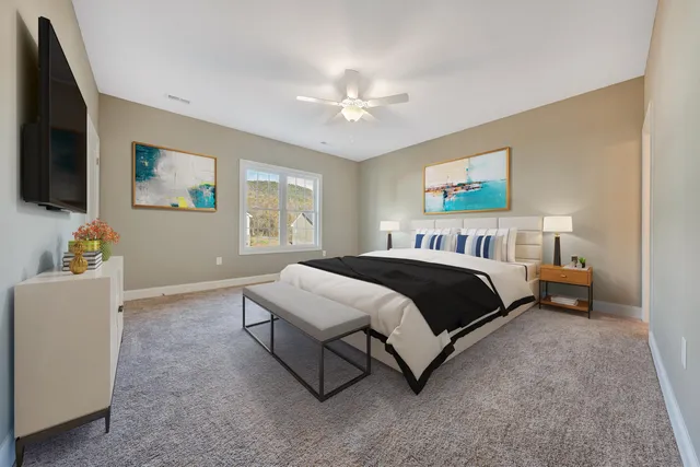 a spacious bedroom with a bed and a flat screen tv