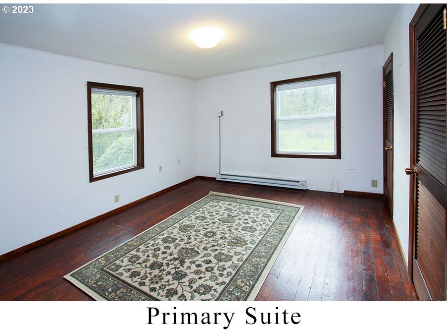 2514 Northwest 209th Street Ridgefield, WA 98642 - Photo 17 of 32 a view of an empty room with wooden floor and a window