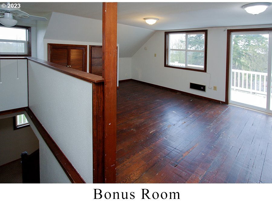 2514 Northwest 209th Street Ridgefield, WA 98642 - Photo 24 of 32 a view of an empty room with wooden floor and a window