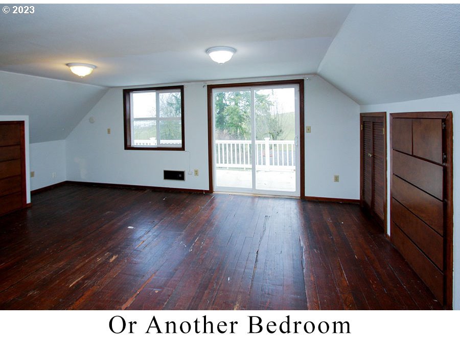 2514 Northwest 209th Street Ridgefield, WA 98642 - Photo 25 of 32 a room with wooden floor and windows