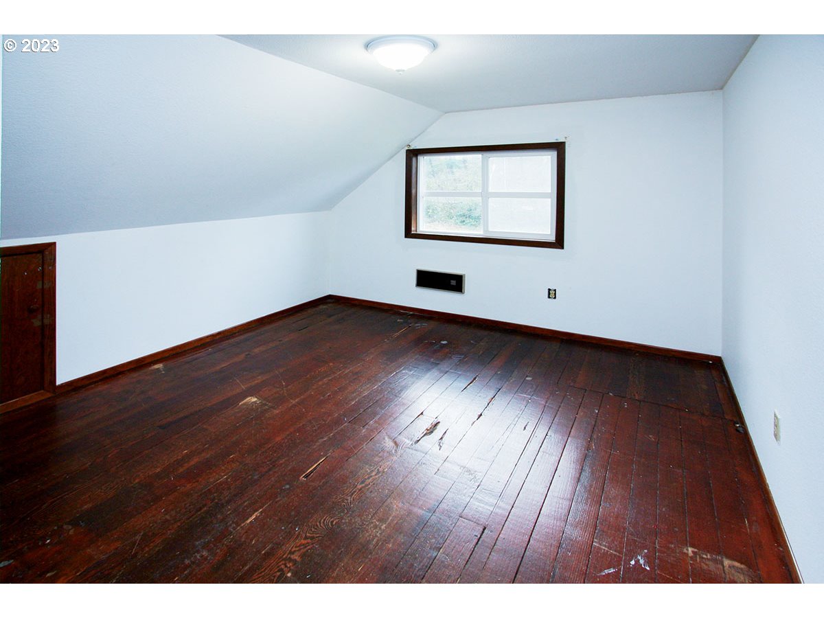 2514 Northwest 209th Street Ridgefield, WA 98642 - Photo 29 of 32 an empty room with wooden floor and windows