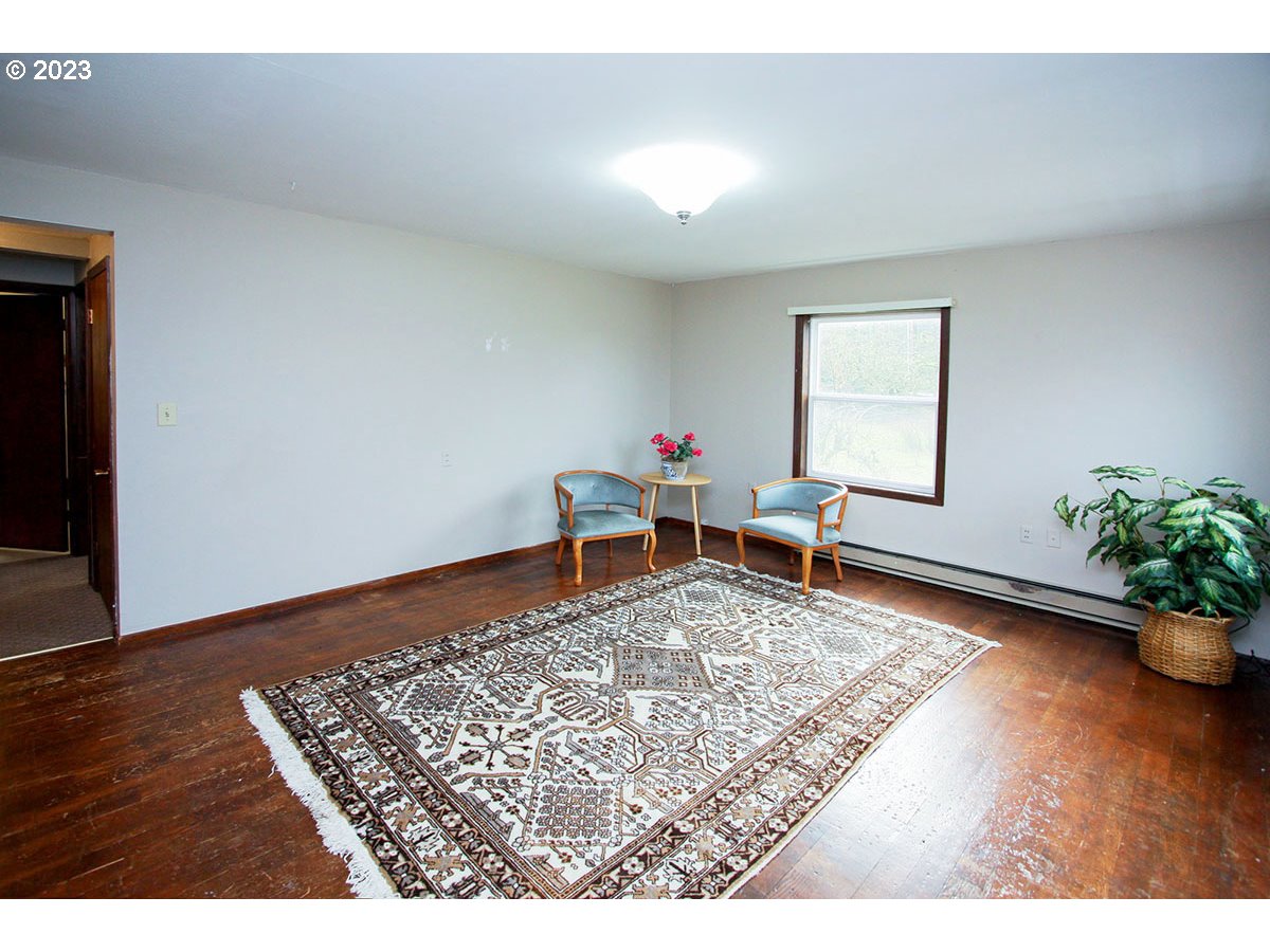 2514 Northwest 209th Street Ridgefield, WA 98642 - Photo 9 of 32 a living room with furniture and a wooden floor
