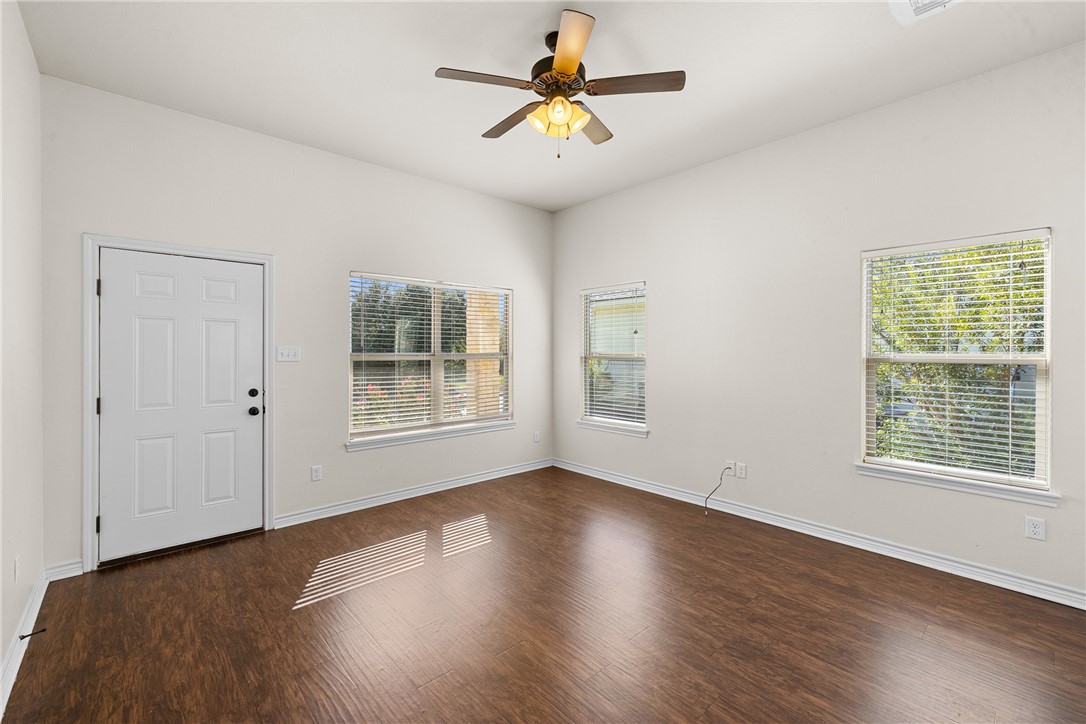930 West 28th Street Bryan, TX 77803 - Photo 12 of 30 a view of a room with wooden floor and a ceiling fan