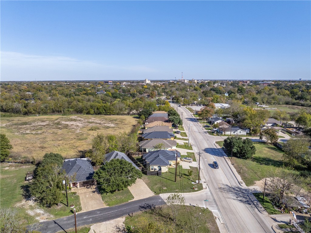 930 West 28th Street Bryan, TX 77803 - Photo 28 of 30 an aerial view of lake and residential houses with outdoor space