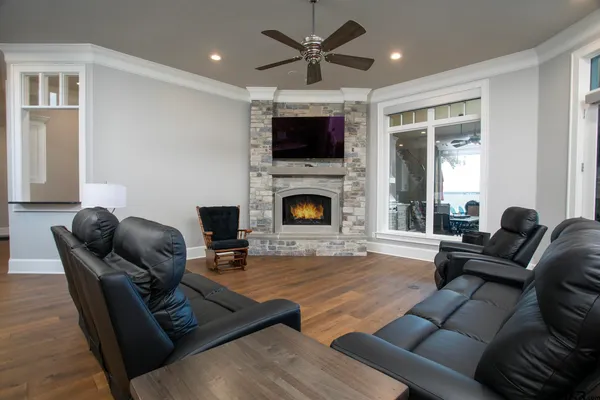 a living room with furniture flat screen tv and a fireplace
