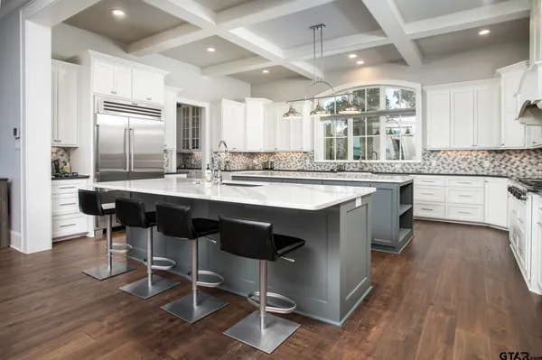a kitchen with counter top space and wooden floor