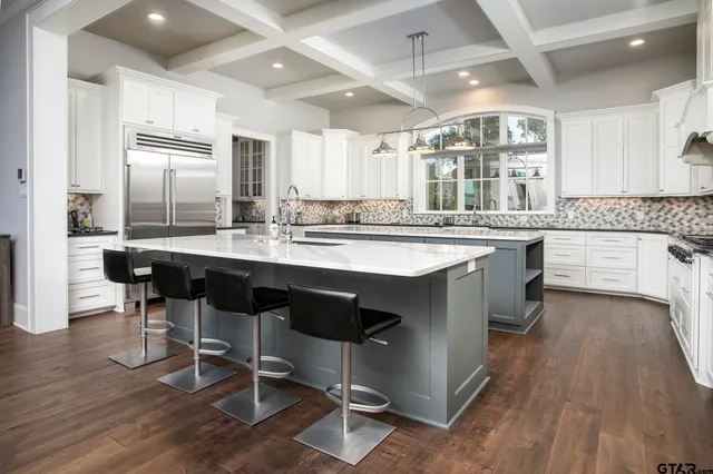 a kitchen with counter top space and wooden floor