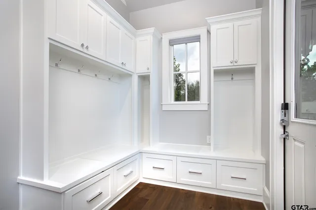 a view of kitchen with wooden floor and cabinets