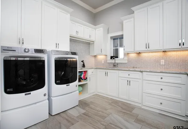 a kitchen with stainless steel appliances white cabinets and white appliances