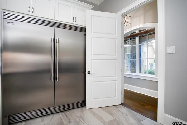 a kitchen with a refrigerator and a window