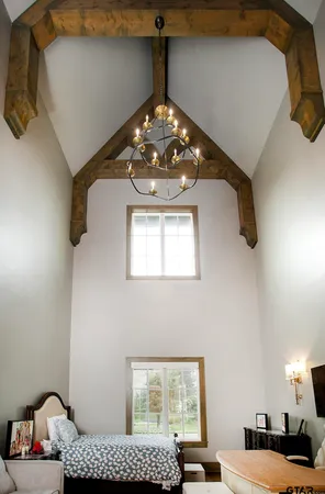 a view of a bedroom with a bed and a chandelier