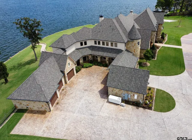an aerial view of a house with a yard