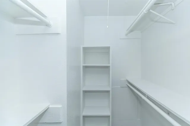 a view of an empty walk in closet