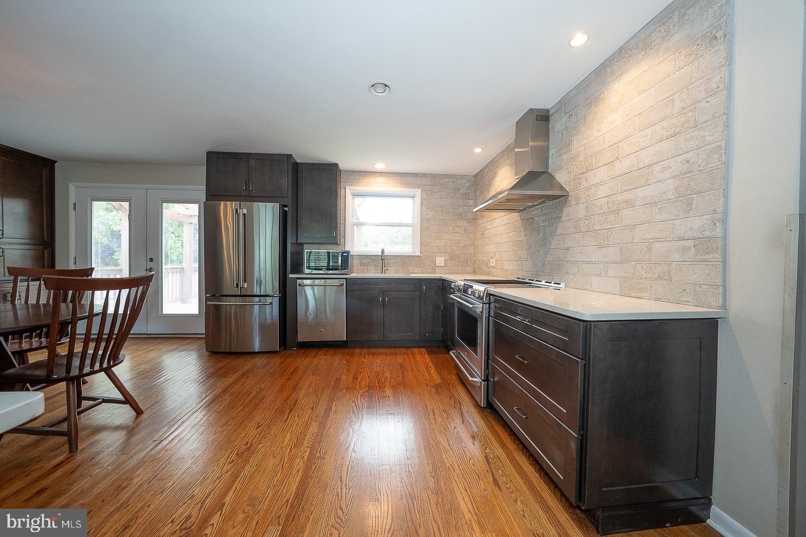 20 Fairview Road Swarthmore, PA 19081 - Photo 16 of 57 a kitchen with stainless steel appliances wooden floors and wooden cabinets