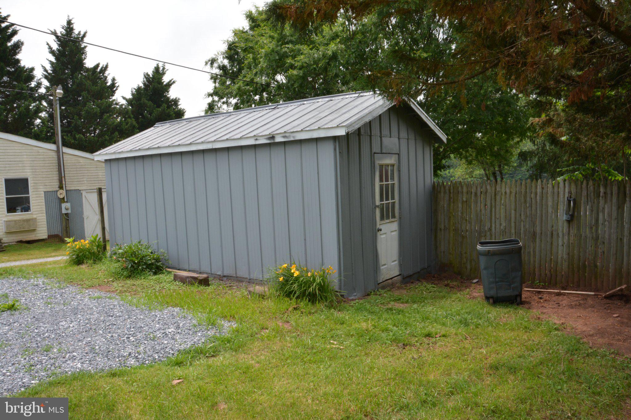 1006 Circle Drive Keymar, MD 21757 - Photo 37 of 45 Charming gray shed in a lush yard.