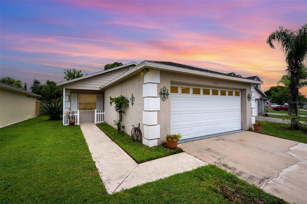 3033 Dunhill Drive Cocoa, FL 32926 - Photo 1 of 1 a front view of a house with a yard and garage