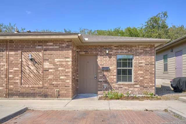 a view of a brick building next to a yard